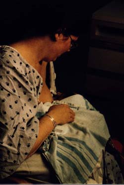 Breastfeeding Adam for the first time 9 days after birth without a supplementary feeding device